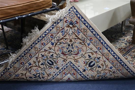 A Persian cream ground rug 270 x 165cm